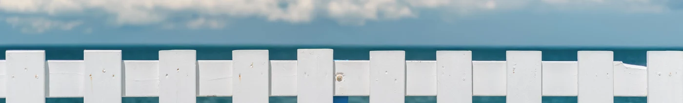 40700bbd-f6e2-40da-a578-30eac3edff98-white-wooden-fence-pier-with-view-blue-sea-cumulus-clouds-horizon-concept-poster-advertising-seaside-vacation-trip-islands-copy-space-advertising-sea-cruises.jpg